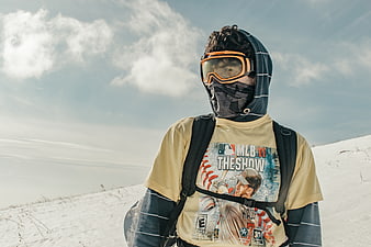 Snowboarder in winter gear on snowy mountain slope