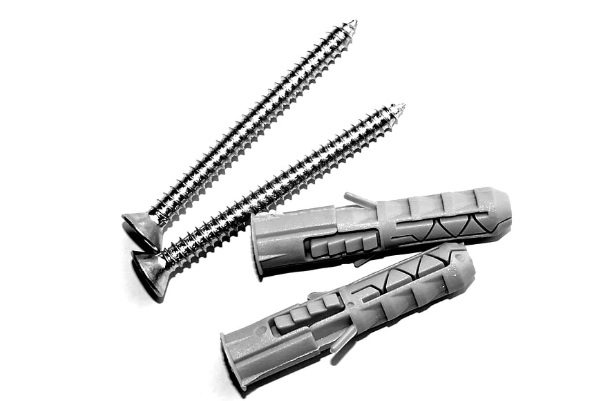 Metal Screws and Plastic Wall Plugs on White Background