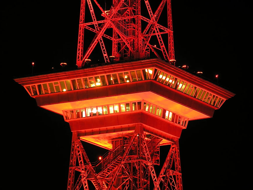 Red illuminated Eiffel Tower observation deck at night