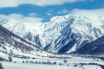 Snowy Alpine Village with Majestic Mountain Peaks