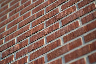 Close-up of red brick wall texture with gray mortar