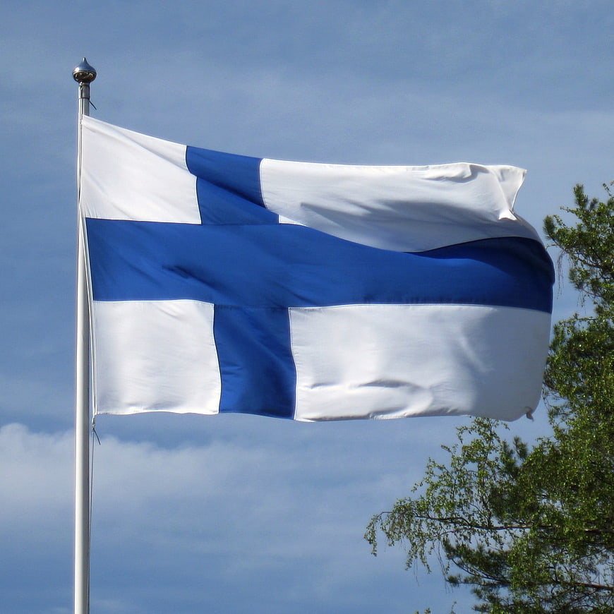 Finnish Flag Waving Against Blue Sky
