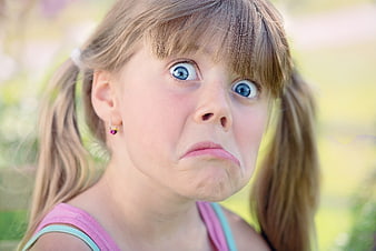 Close-up portrait of young girl making funny face