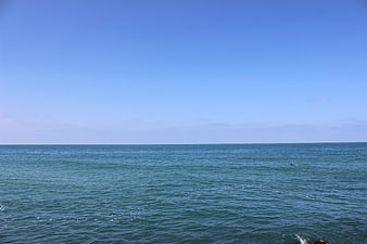 Serene Blue Sea Horizon Under Clear Sky