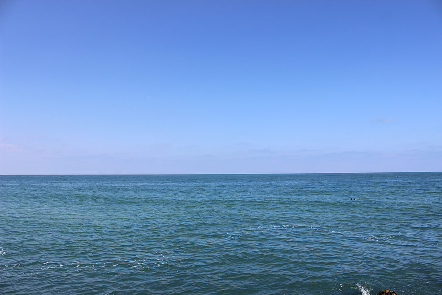 Serene Blue Sea Horizon Under Clear Sky