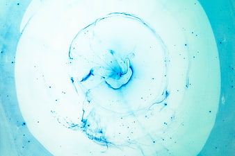Abstract blue ink swirl in white liquid background