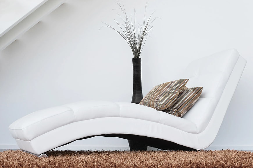 Modern White Leather Chaise Lounge with Striped Pillows