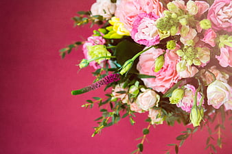 Pink floral bouquet on magenta background with copy space