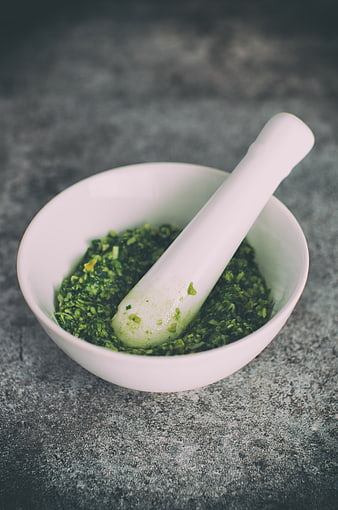 Fresh Green Herb Pesto in White Mortar and Pestle