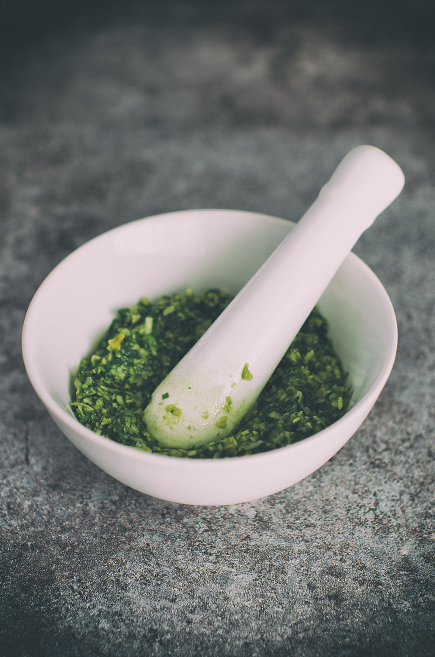 Fresh Green Herb Pesto in White Mortar and Pestle