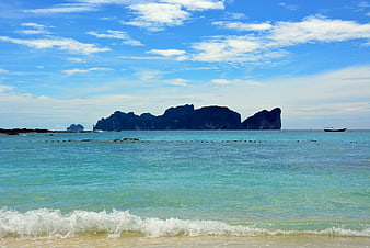 Tropical beach with turquoise water and limestone cliffs