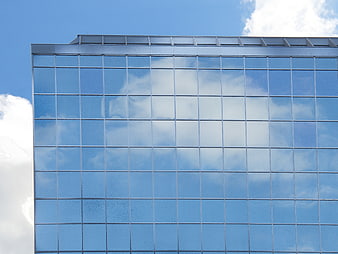 Modern Glass Office Building Facade with Sky Reflection