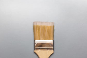 Close-up of wooden paint brush on gray background