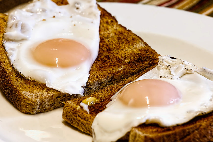 Fried Eggs on Toasted Brown Bread Close-Up