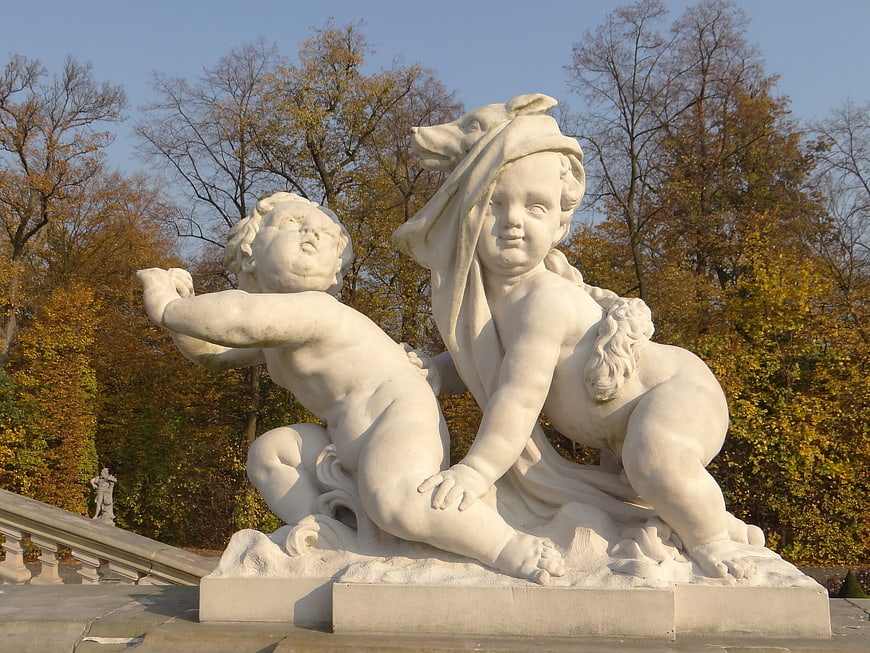 White Marble Putto Sculpture in Autumn Park