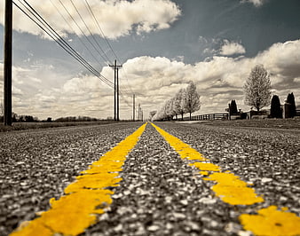 Low Angle View of Yellow Road Lines on Asphalt