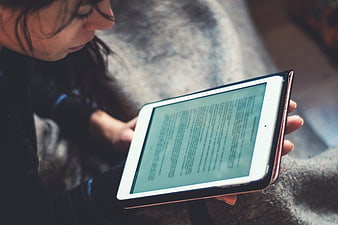 Woman Reading Digital Text On Tablet Device
