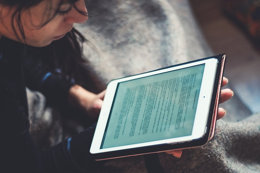 Woman Reading Digital Text On Tablet Device