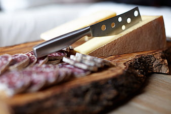 Artisanal Cheese and Salami on Rustic Wooden Board