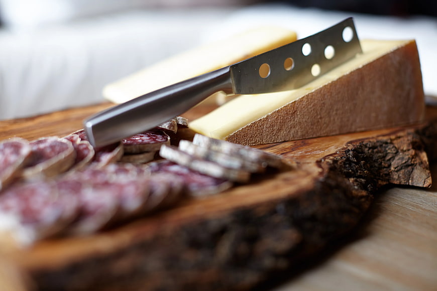 Artisanal Cheese and Salami on Rustic Wooden Board