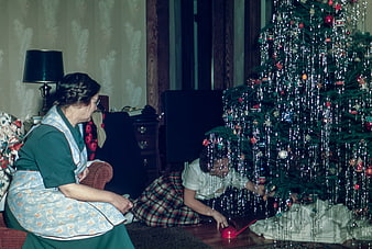 Vintage Christmas Scene with Woman and Child Decorating Tree