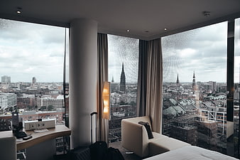 Luxury Hotel Room Interior With Rainy City Skyline View