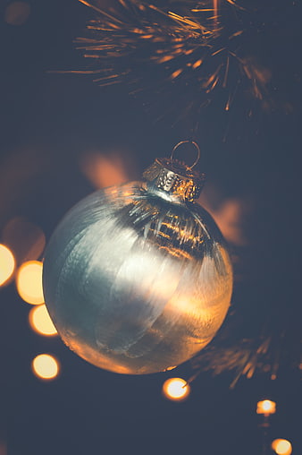 Silver Christmas Bauble with Golden Bokeh Lights