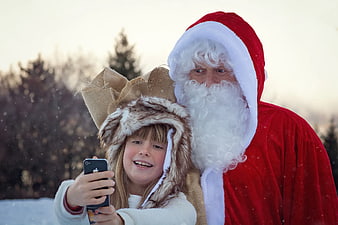 Santa Claus and Girl Taking Selfie in Snow