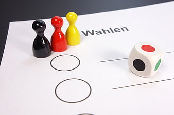 German election concept with black, red, and gold pawns on a ballot