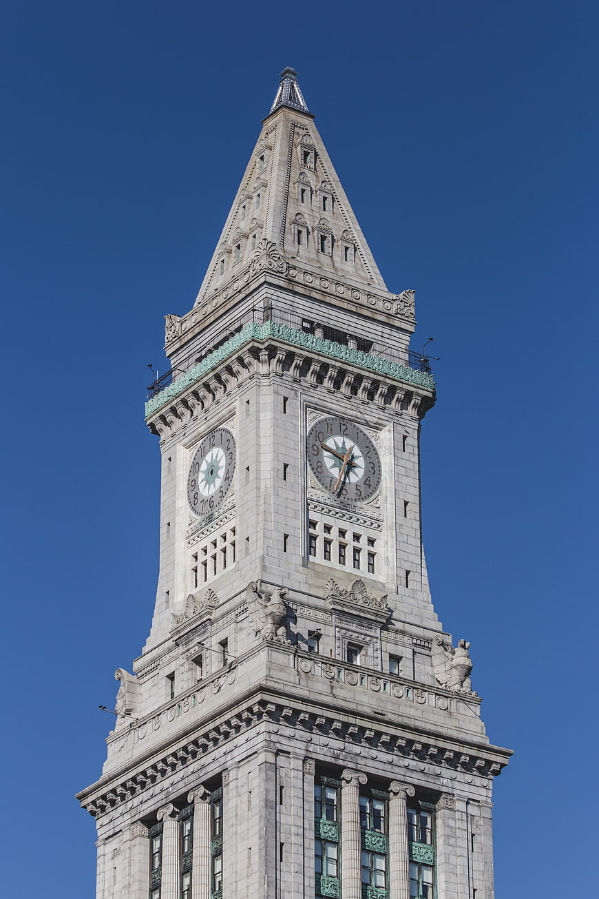 Low angle view of ornate clock tower against blue sky