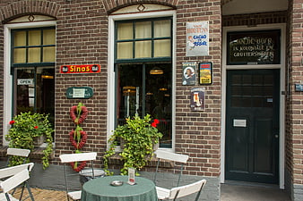 Traditional Dutch Brick Cafe Facade with Vintage Signs