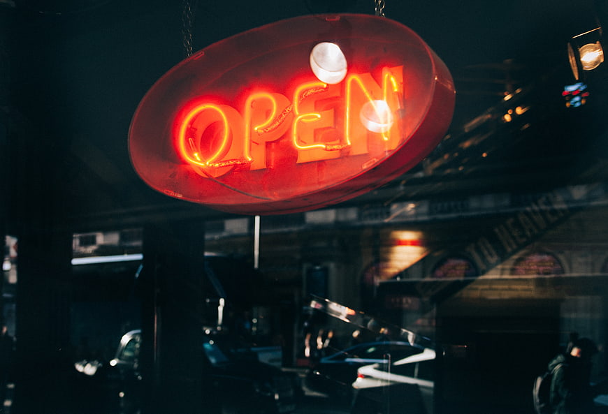 Red Neon Open Sign Hanging in Window at Night