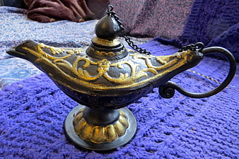 Vintage Brass Genie Lamp on Purple Fabric Background