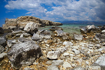 Rugged Rocky Coastline with Turquoise Sea and Blue Sky