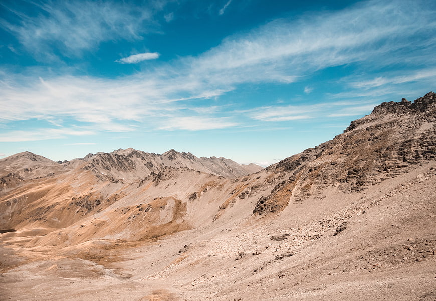 Arid Desert Mountain Landscape with Blue Sky and Clouds