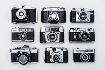 Grid of nine vintage film cameras on white background