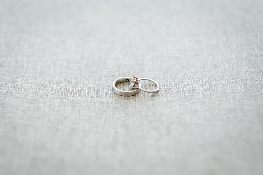 Silver Wedding Rings on Textured Fabric Background