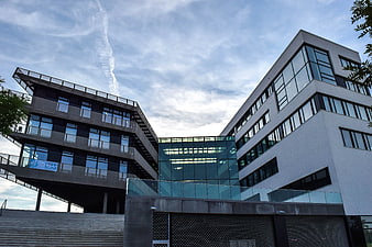 Modern multi-story office building with glass facade and concrete exterior