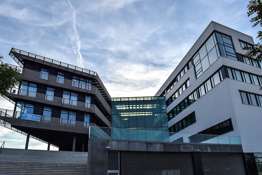 Modern multi-story office building with glass facade and concrete exterior