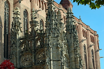 Gothic Cathedral Facade with Intricate Stone Spires and Brick Walls