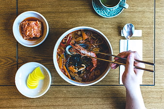 Top View of Korean Seafood Stew with Kimchi and Pickles