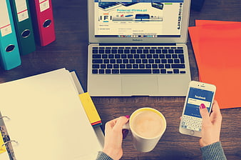 Overhead view of workspace with laptop, smartphone, and coffee