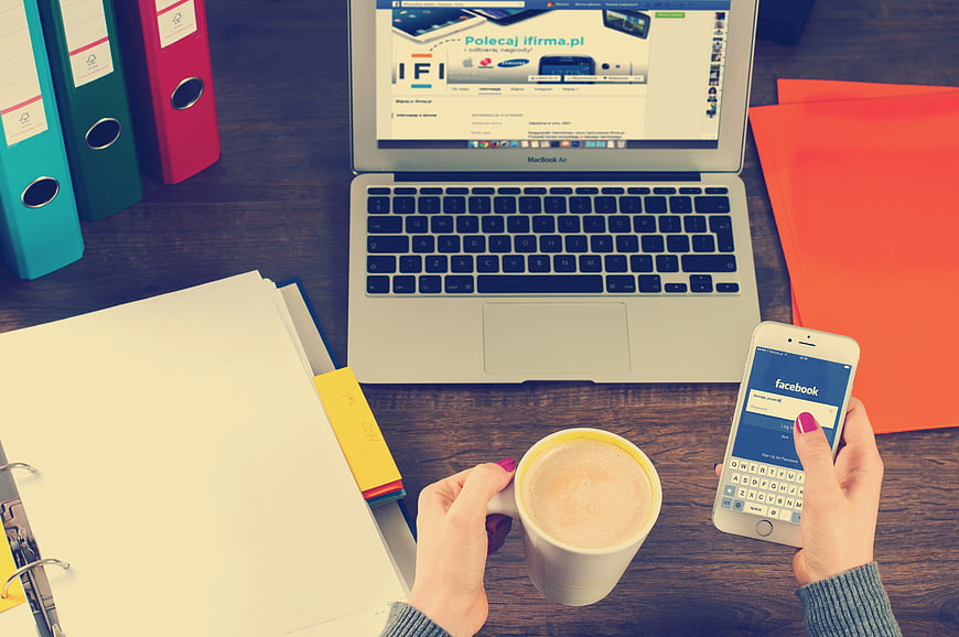 Overhead view of workspace with laptop, smartphone, and coffee