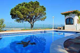 Luxury swimming pool with Mediterranean villa and sea view