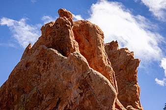 Red Rock Formation Against Blue Sky with Clouds