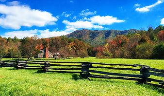 Rural Farmhouse With Split Rail Fence In Autumn Meadow