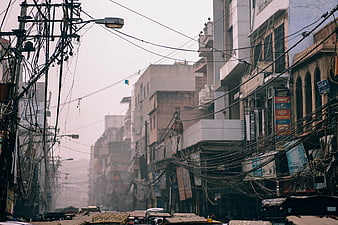 Chaotic urban street scene with tangled power lines in India