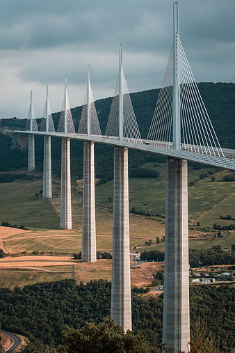 Millau Viaduct cable-stayed bridge over green valley