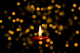 Red Candle with Golden Bokeh Background