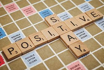 Positive Stay Scrabble Tiles on Game Board